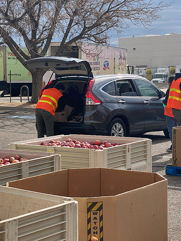 Car dropping off food for at a distribution event